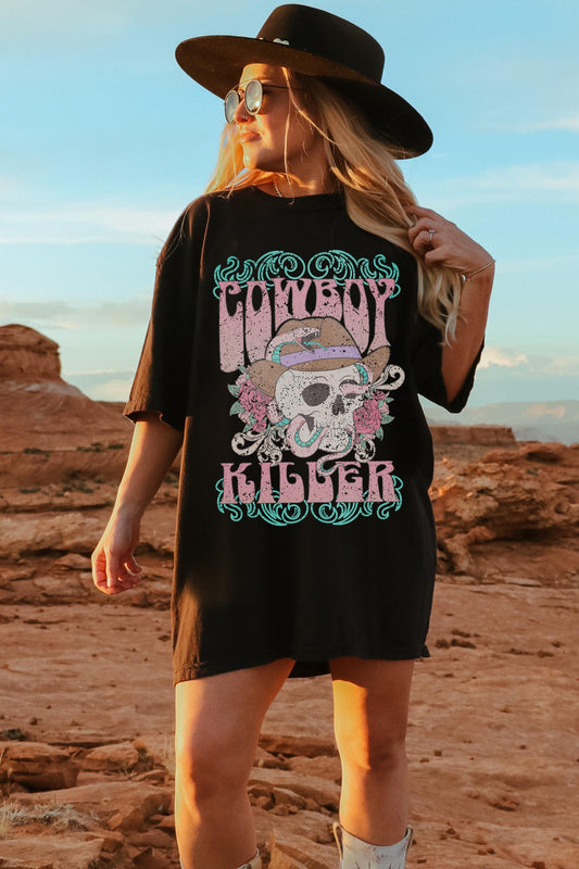 Oversized black comfort colors tshirt featuring a western graphic of a cowboy skull and snake with the words Cowboy Killer in pastel colors